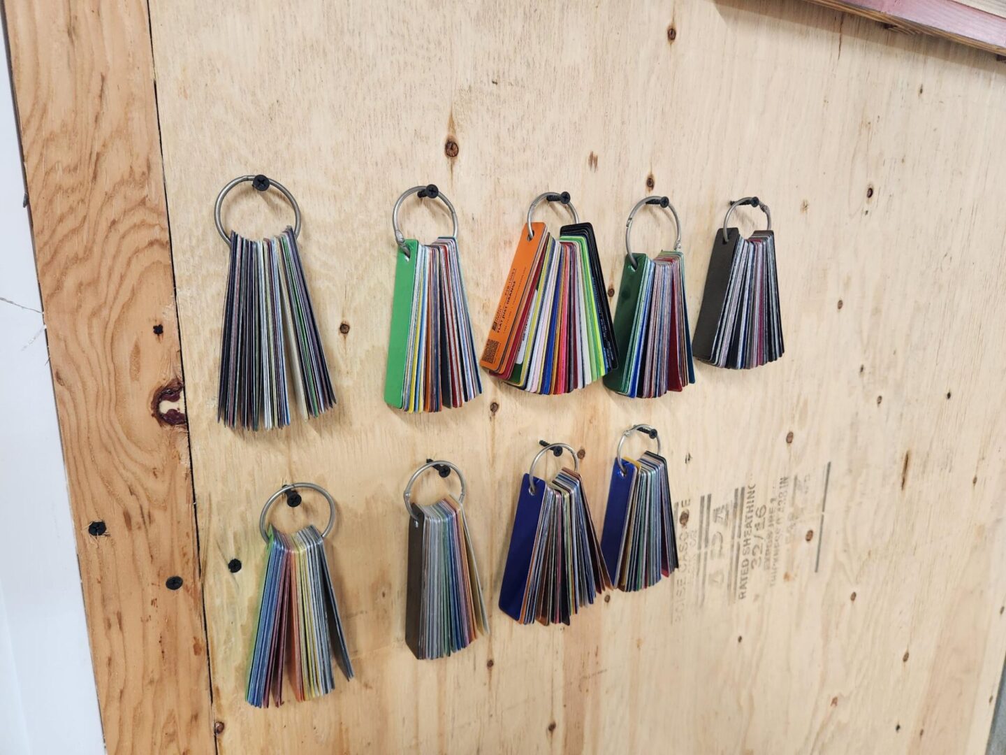 A wall with many different colored keys hanging on it.