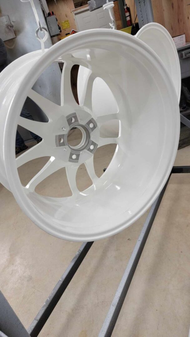 A closeup look at a rim of a wheel in white color