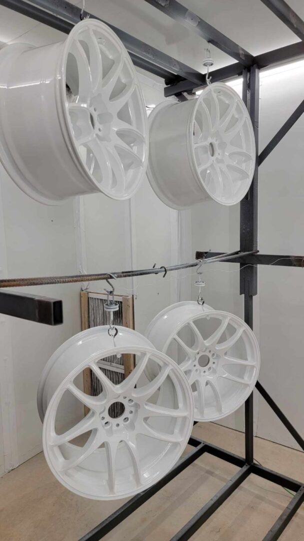 A closeup look at wheel rims hanged and Coated white color.